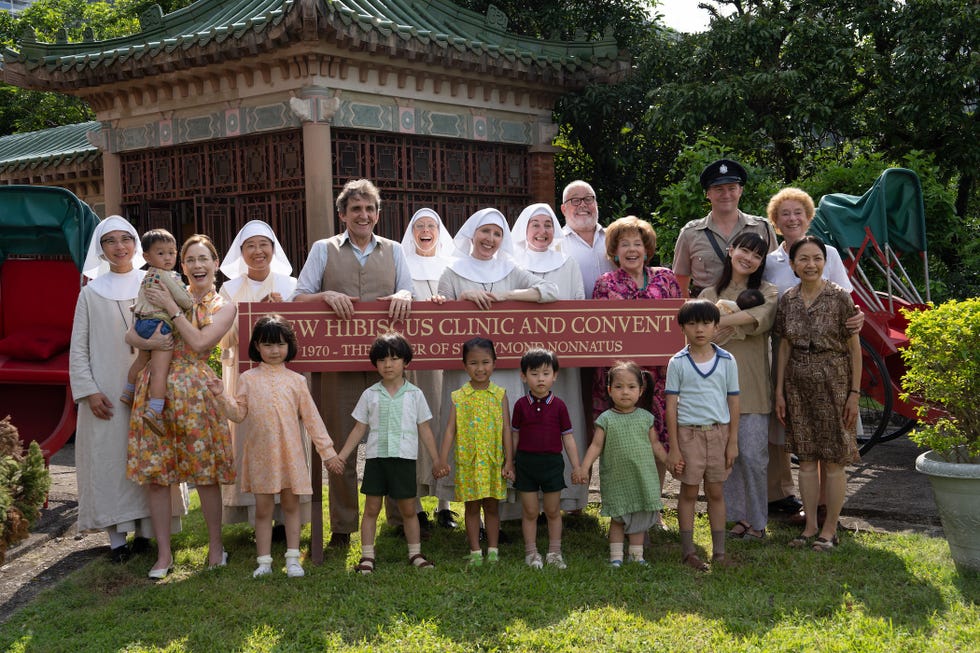 call the midwife christmas special 2025 in hong kong, the nuns, doctors, nurses and children standing for a picture