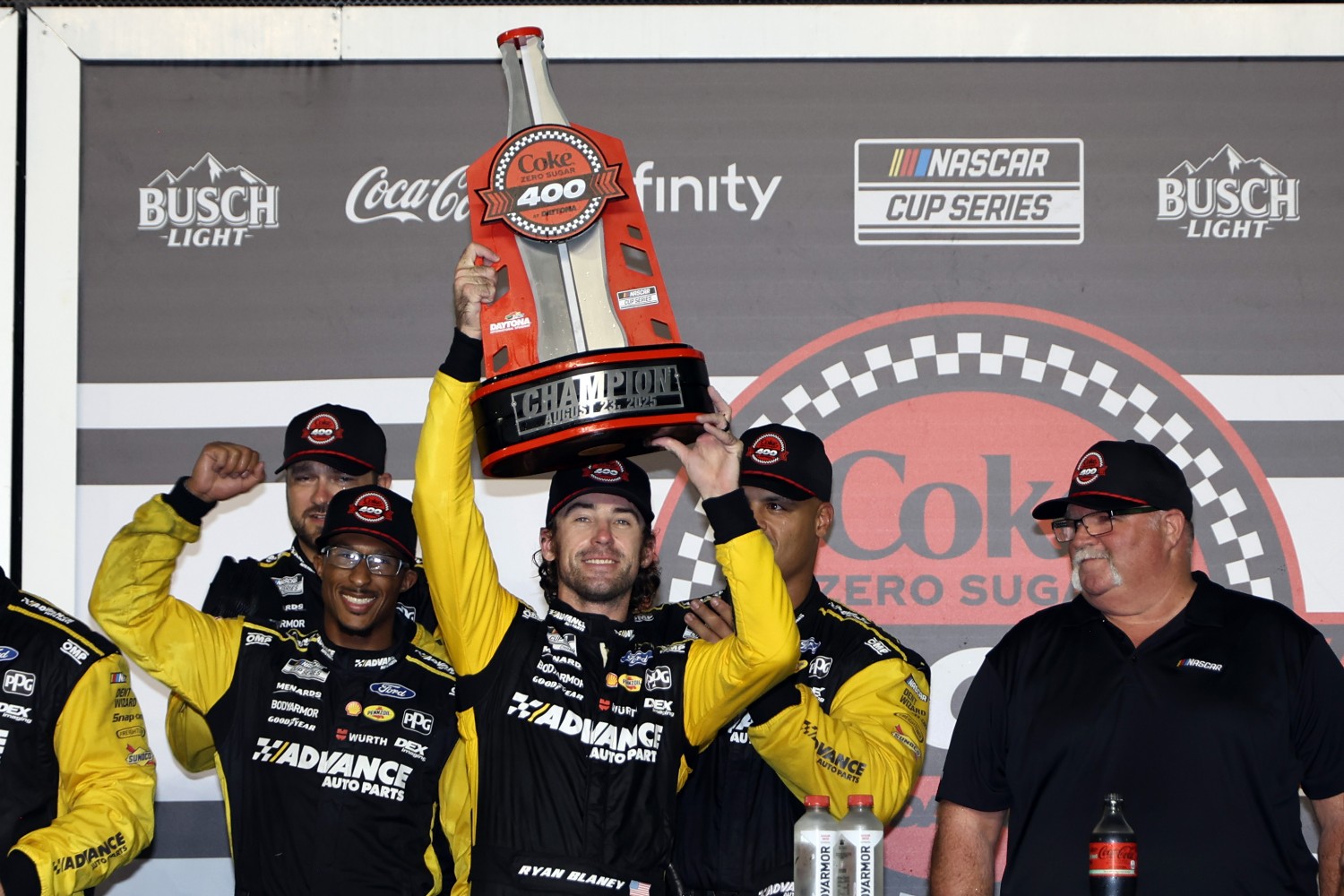 Ryan Blaney, driver of the #12 Advance Auto Parts Ford, celebrates with the trophy in victory lane after winning the NASCAR Cup Series Coke Zero Sugar 400 at Daytona International Speedway on August 23, 2025 in Daytona Beach, Florida. (Photo by James Gilbert/Getty Images for NASCAR)