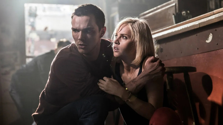 Nicholas Hoult and Felicity Jones as Casey Stein and Juliette Marne, embracing in fear in Collide
