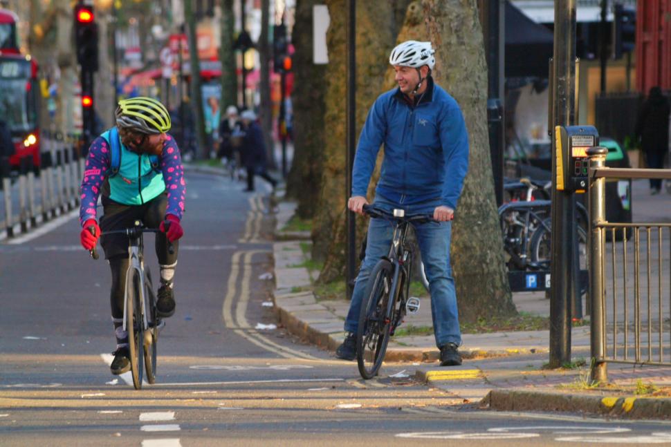 Cyclists in London talking in cycle lane 