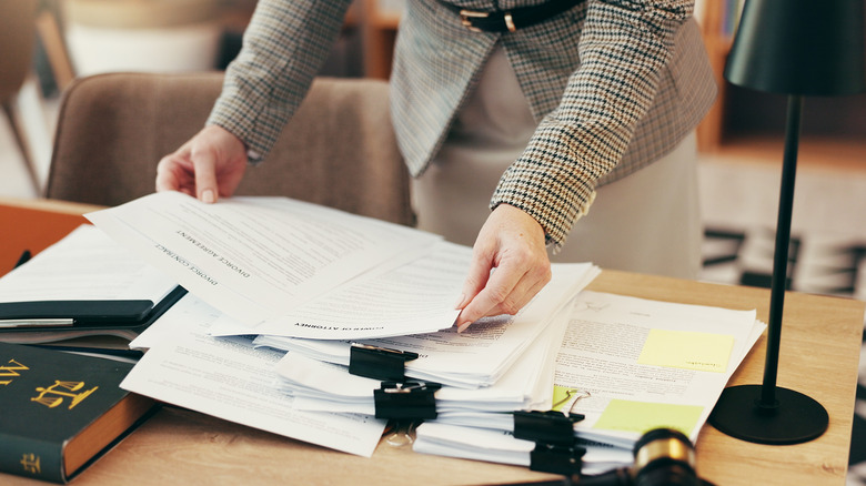 A person working with legal documents on a table
