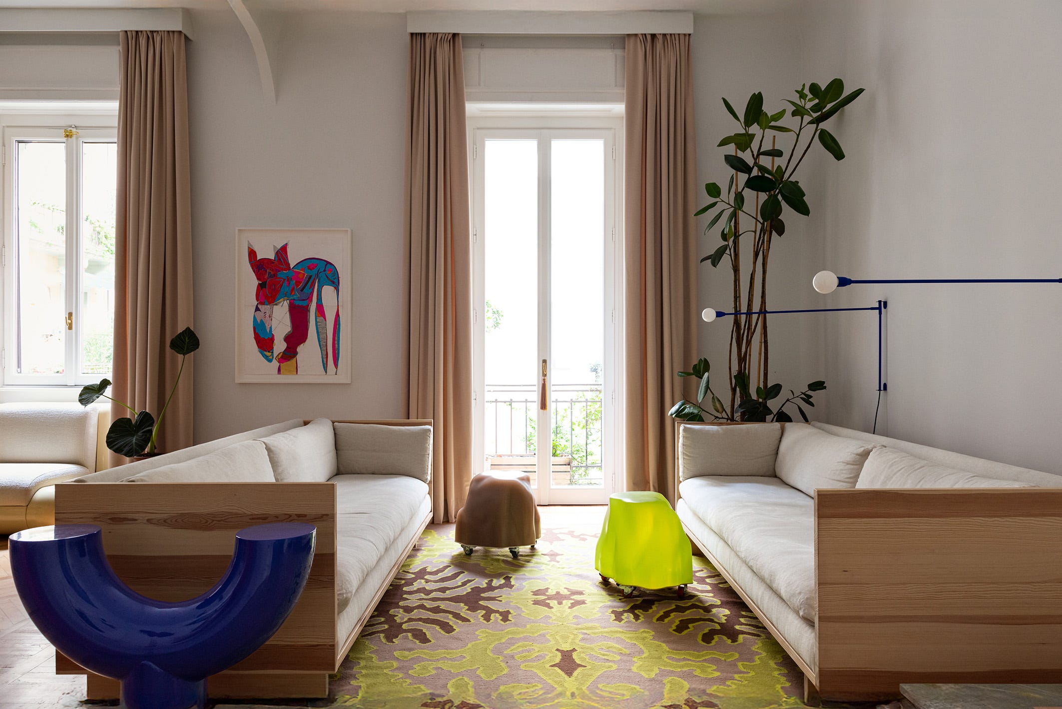 Modern living room featuring artistic decor and vibrant furniture.