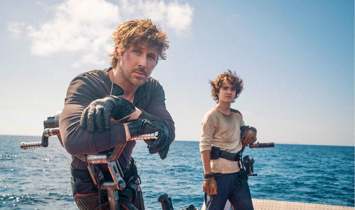 A man and a boy on a watercraft on the ocean