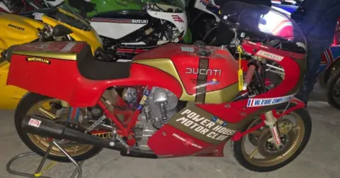 FBI A motorcycle. Its red and says Ducati