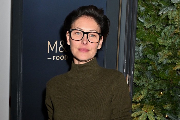 Emma Willis smiling ahead, wearing a green turtleneck jumper.