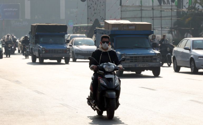 epa12541557 An Iranian man wears a face mask as he rides a scooter on a street during a heavy air pollution in Tehran, Iran, 22 November 2025. Due to heavy air pollution in the capital city, the Iranian Health Ministry announced that elderly and sick people should stay indoors. The government announced that kindergartens and pre-elementary schools in Tehran would be closed for five days. In some other cities, schools and universities have also closed due to heavy air pollution. EPA/ABEDIN TAHERKENAREH