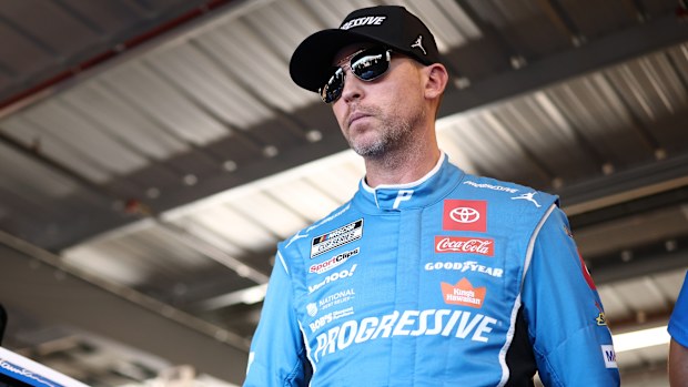 Denny Hamlin, driver of the #11 Progressive Toyota, looks on in the garage area.