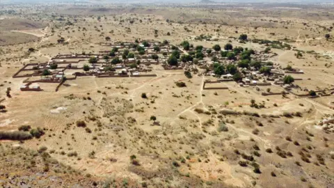 Gift Ufuoma/BBC An aerial view showing the remote location of Nukuru village on a savannah plain.