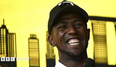 Biniam Girmay smiles during a press conference