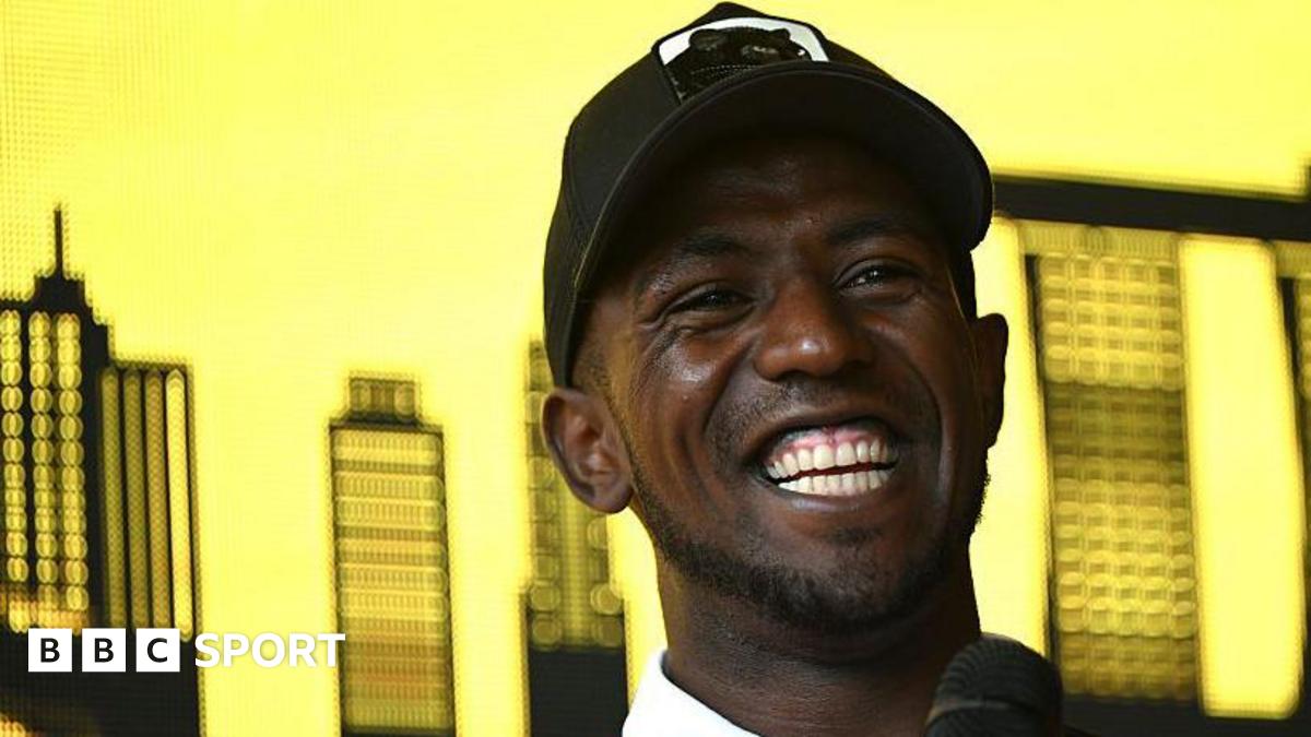 Biniam Girmay smiles during a press conference