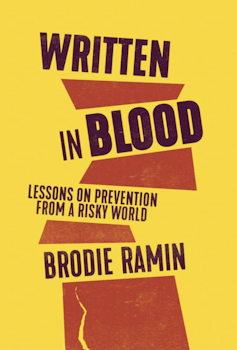 A red-and-yellow book cover that reads: Written in Blood