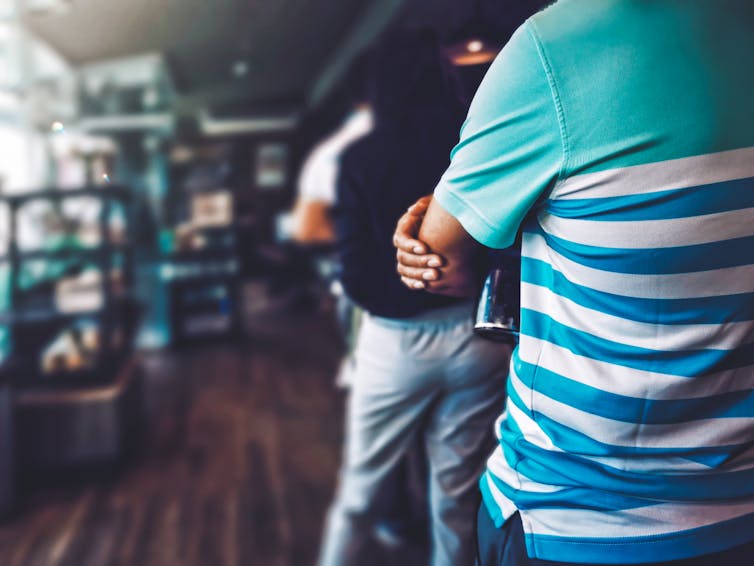 queue of people waiting to be served in a shop or cafe