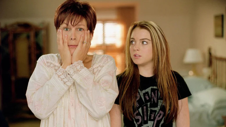 Jamie Lee Curtis as Tess in nightgown with hands on the side of her face standing next to Lindsay Lohan as Anna looking at her in Freaky Friday