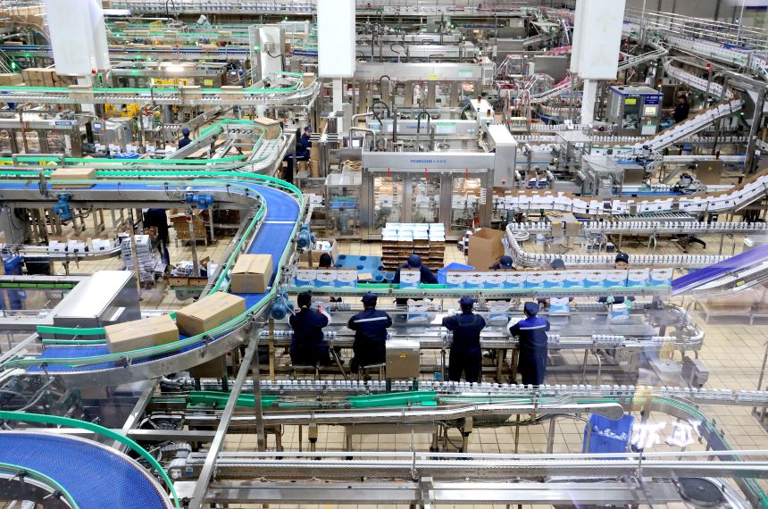 Employees work at the production line at an intelligent packaging workshop of Mengniu Dairy, in Suqian, Jiangsu Province of China, on December 2, 2025.