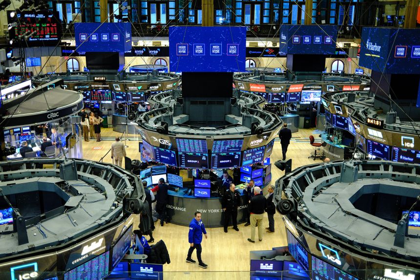 Traders work on the floor of the New York Stock Exchange at the opening bell in New York on December 16.