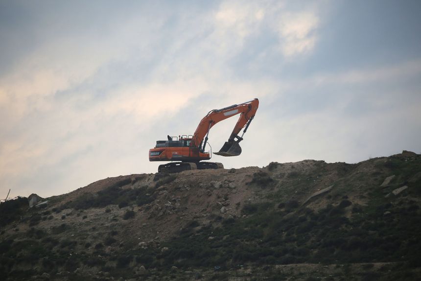 Israeli bulldozers are seen working in the abandoned Jewish settlement of Sa'anur, south of Jenin in the West Bank, in preparation for the return of Jewish settlers, following the Israeli government's approval of their return, on December 23, 2025.