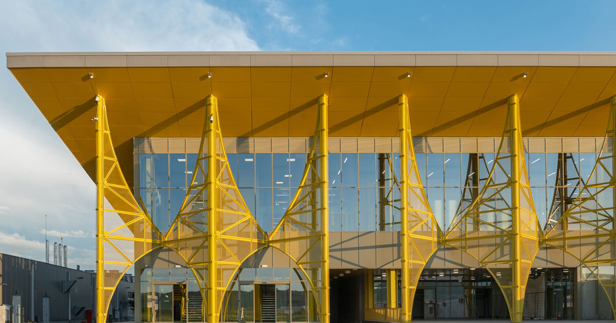 yellow metal arches frame airport’s terminal extension in romania