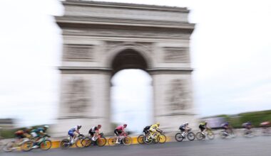 UAE Team Emirates - XRG team's Slovenian rider Tadej Pogacar wearing the overall leader's yellow jersey cycles with the pack of riders (peloton) past the Arc de Triomphe on Place Charles de Gaulle during the 21st and final stage of the 112th edition of the Tour de France cycling race, 132.3 km between Mantes-la-Ville and Paris' Champs-Elysees Avenue, on July 27, 2025. (Photo by Anne-Christine POUJOULAT / AFP)