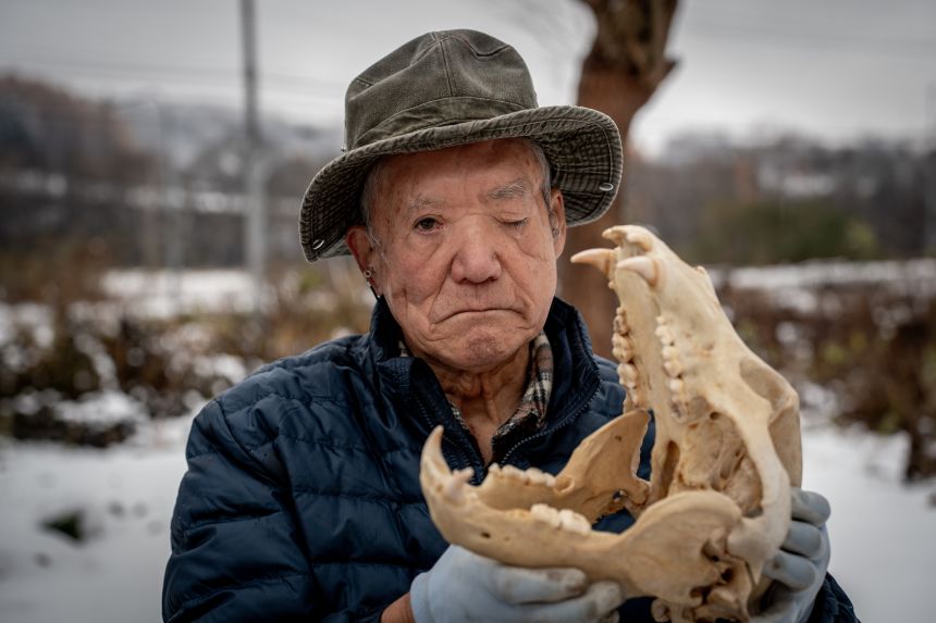 Hunter Katsuo Harada holds a bear skull.
