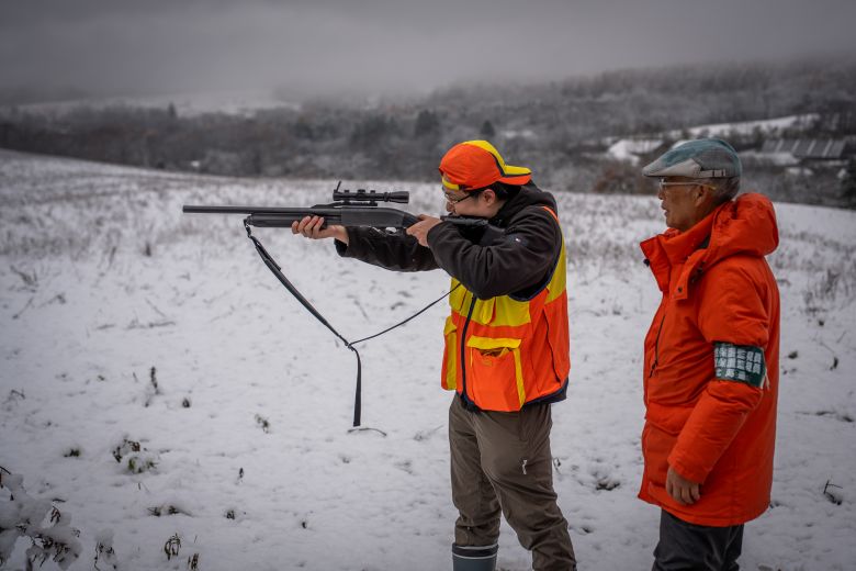 Bear hunter Haruo Ikegami teaching his apprentice.