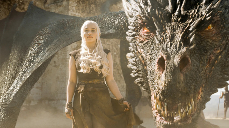 Daenerys Targaryen (Emilia Clarke) stands beside a dragon on Game of Thrones