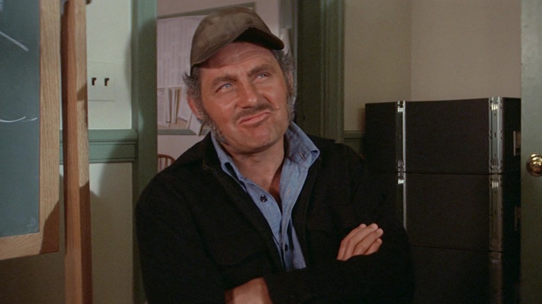 Quint looking rueful next to a chalkboard in Jaws