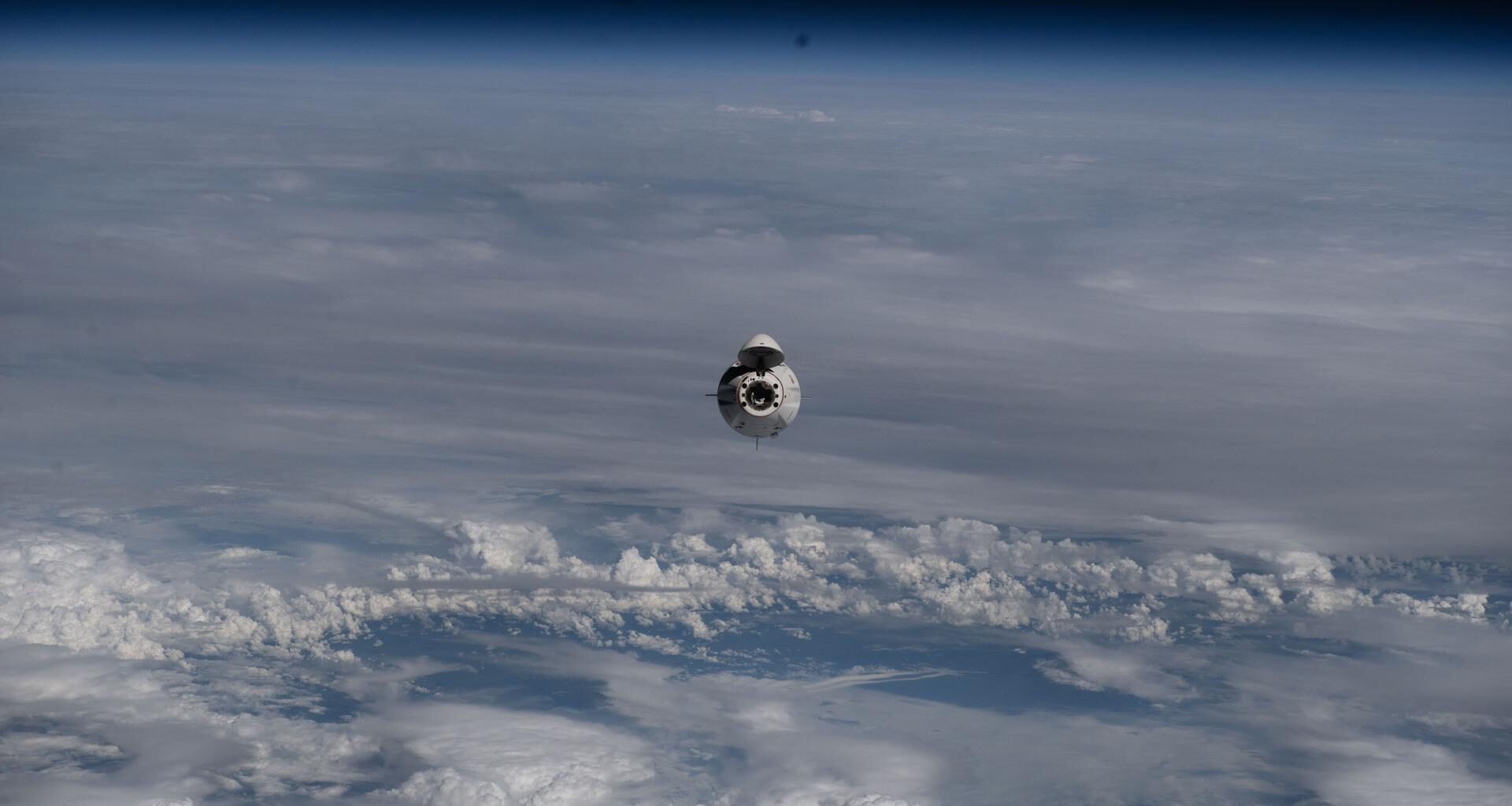 The SpaceX Dragon crew spacecraft ferrying NASA's Crew-11 mission approaches the International Space Station as both spacecraft soared 262 miles above a cloudy northeastern China.