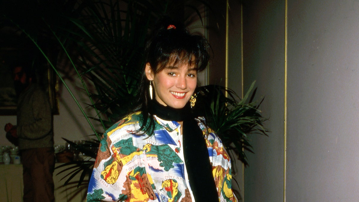 Jill Schoelen in classic 1980s fashion smiling.