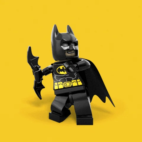 An animated LEGO Batman figure holding a batarang in its right hand moves from pose to pose in a loop.