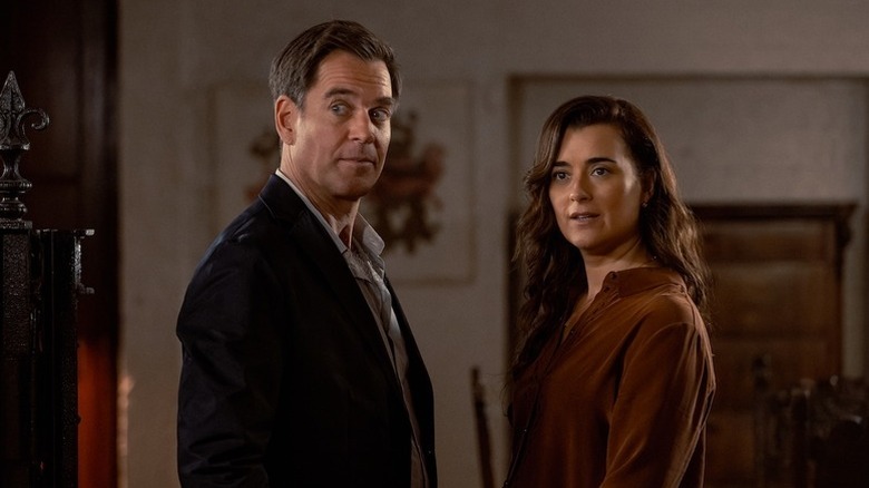 Tony DiNozzo (Michael Weatherly) and Ziva David (Cote de Pablo) stand together looking outside a doorway in NCIS: Tony & Ziva
