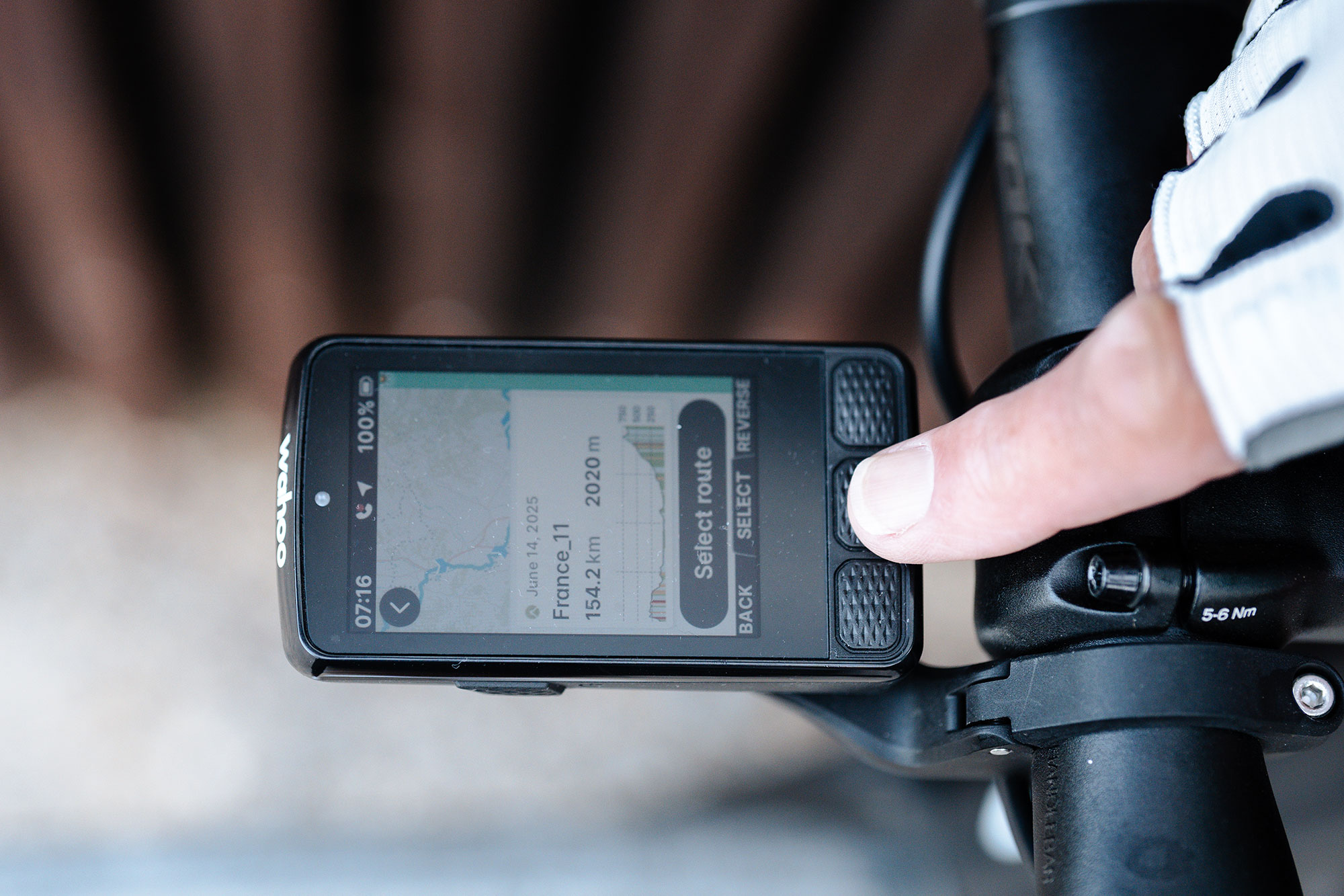 Wahoo Elemnt Roam 3 pictured mounted on bars from above, showing select route screen