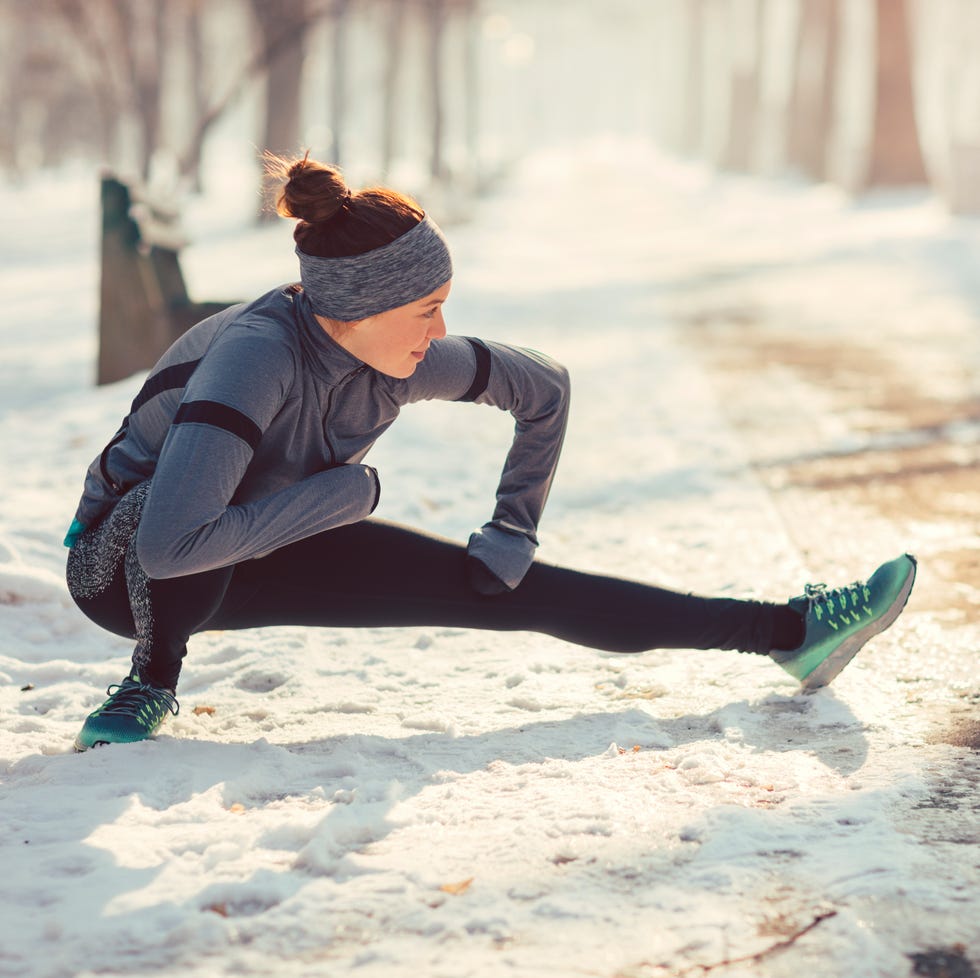 woman stretching outdoors in the snow