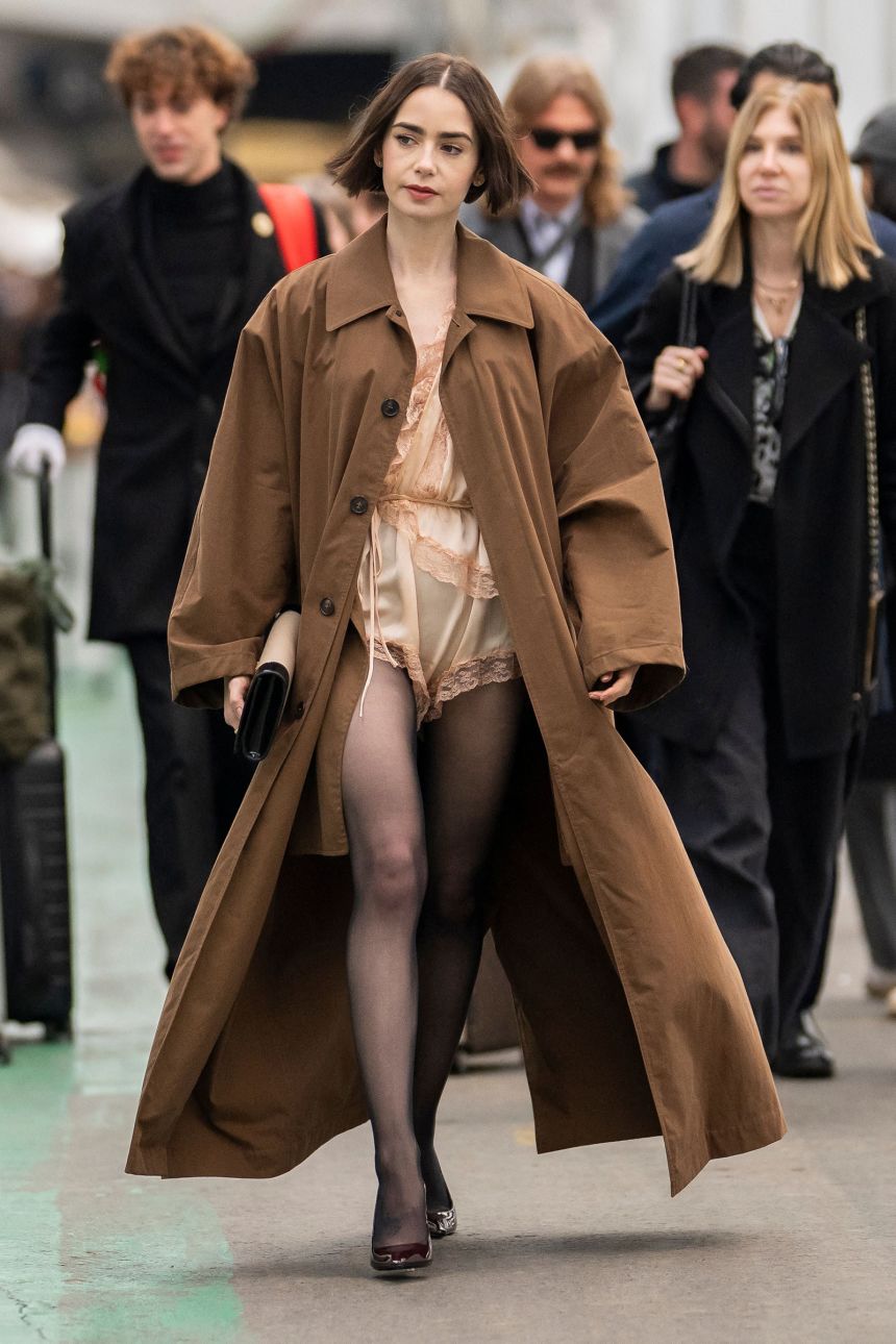 Lily Collins covered her romper with an ankle-skimming trench coat.