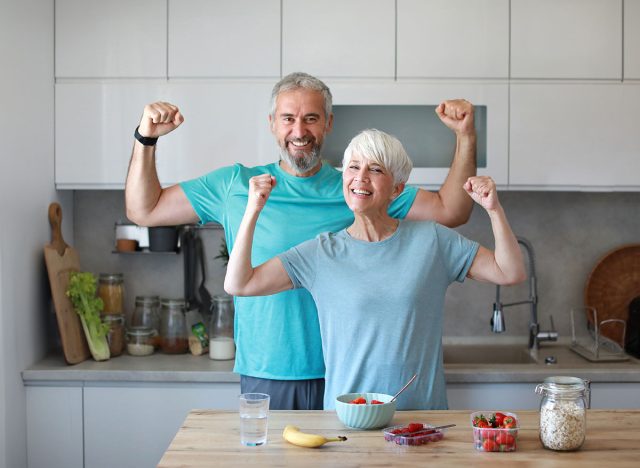 Portrait of a senior mature couple having a healthy breakfast after fitness exercise training in the morning at home