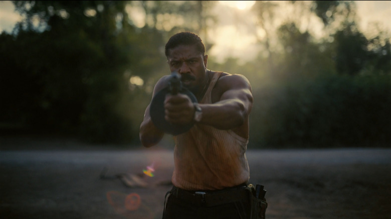 Elijah 'Smoke' Moore firing a machine gun at dawn in Sinners