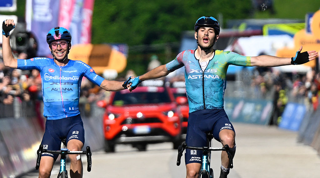 XDS Astana Team's Italian rider Christian Scaroni (R) celebrates alongside second placed XDS Astana Team's Italian rider Lorenzo Fortunato after victory as he crosses the finish line of the 16th stage of the 108th Giro d'Italia cycling race of 203kms from Piazzola sul Brenta to San Valentino on May 27, 2025. (Photo by Ivan Benedetto / AFP)