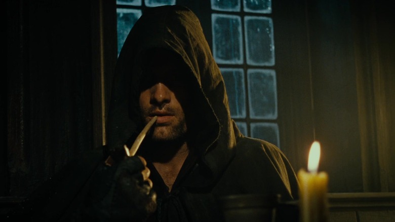 Aragorn smoking a pipe in the inn at Bree in The Lord of the Rings: The Fellowship of the Ring