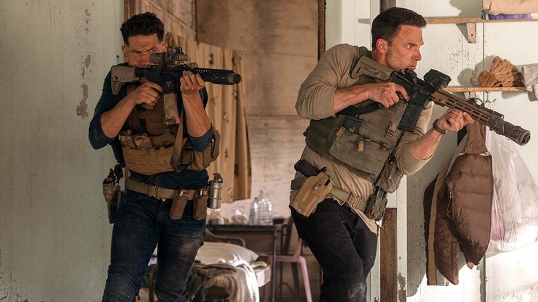 Jon Bernthal as Braxton and Ben Affleck as Christian Wolff holding guns in The Accountant 2