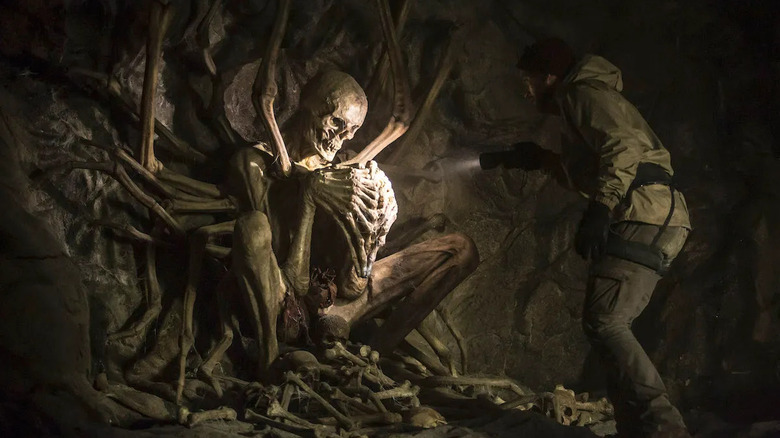 An explorer discovers a large, inhuman skeleton in The Empty Man