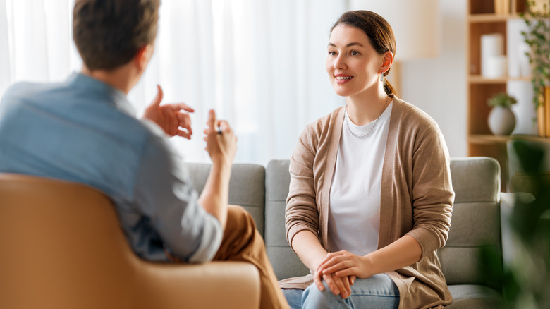 A woman talking to a therapist, both sitting in an office