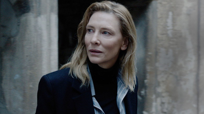 Cate Blanchett as Lydia Tár, walking through an abandoned corridor in Tár