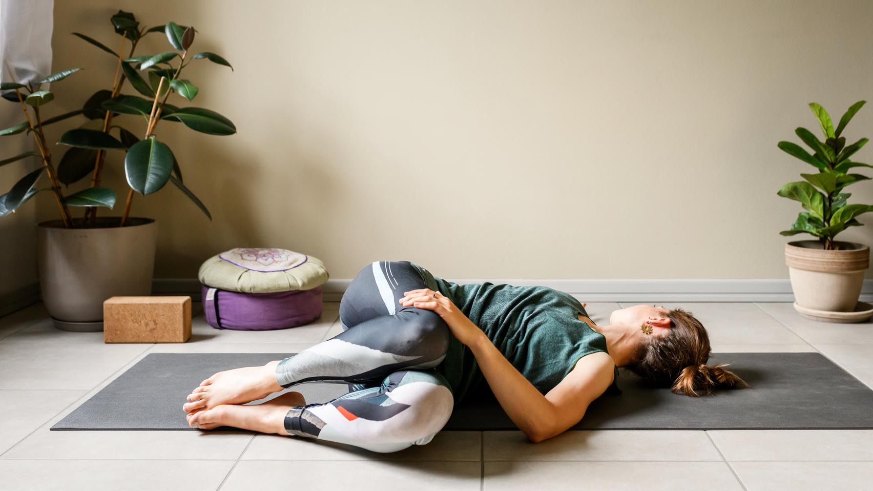 a woman doing a supine twist stretch