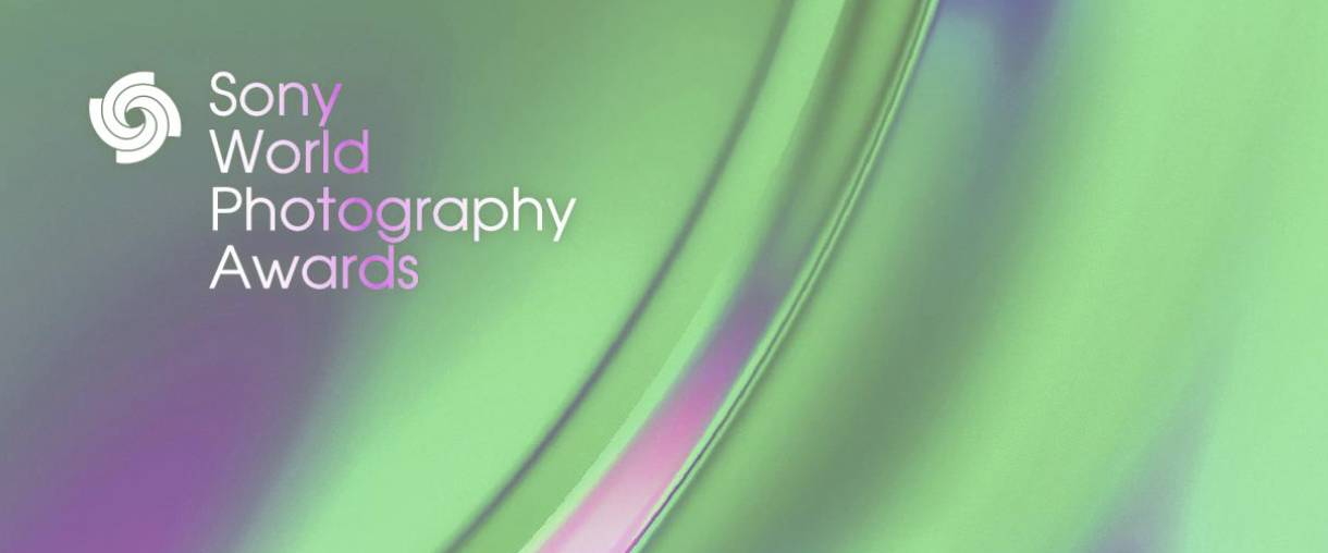 A vibrant banner for the Sony World Photography Awards, featuring the text logo on a dynamic, abstract background of swirling green and magenta colors.