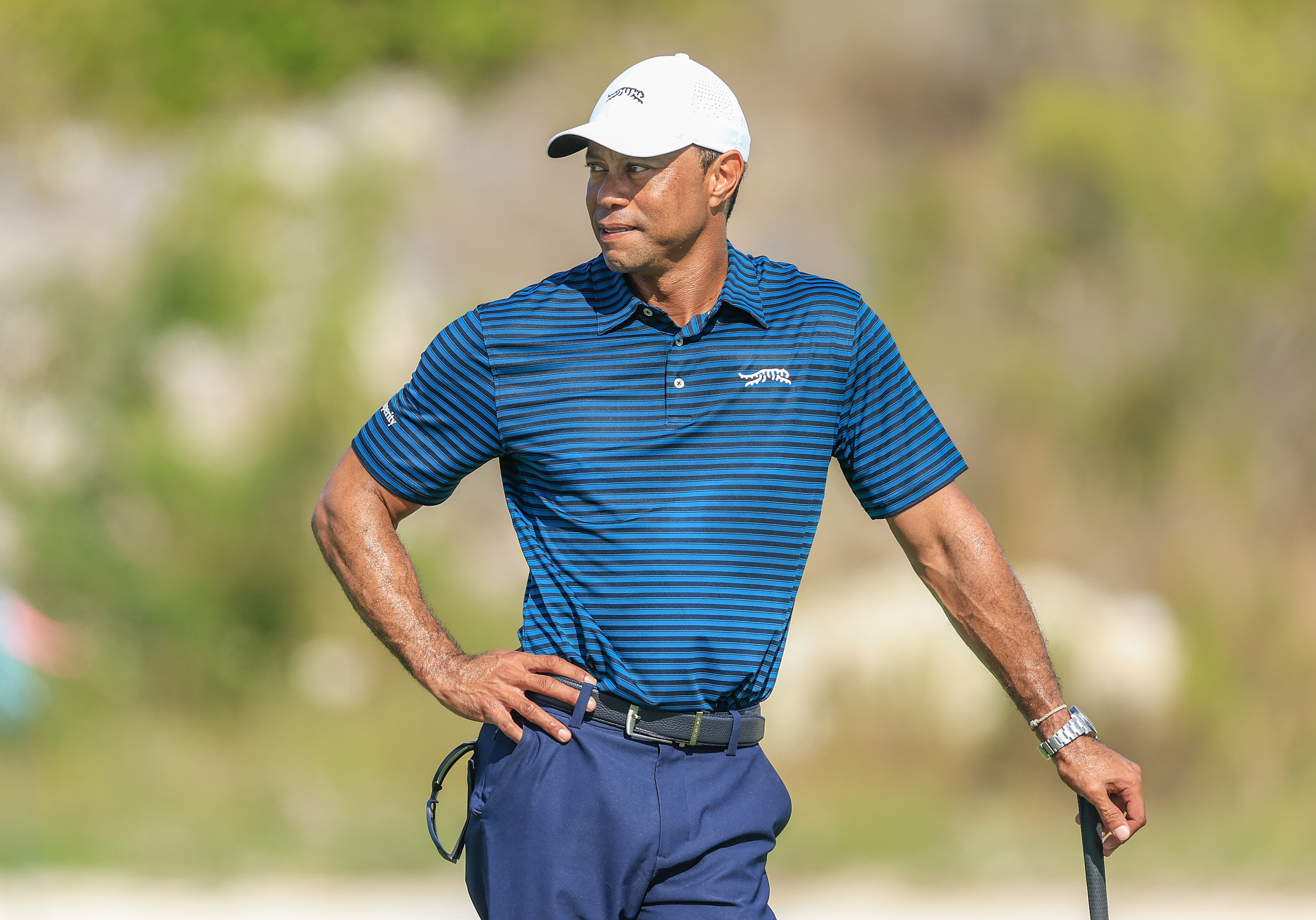 Tiger Woods holds one of Scottie Scheffler's clubs during the pro-am for the Hero World Challenge 2025.