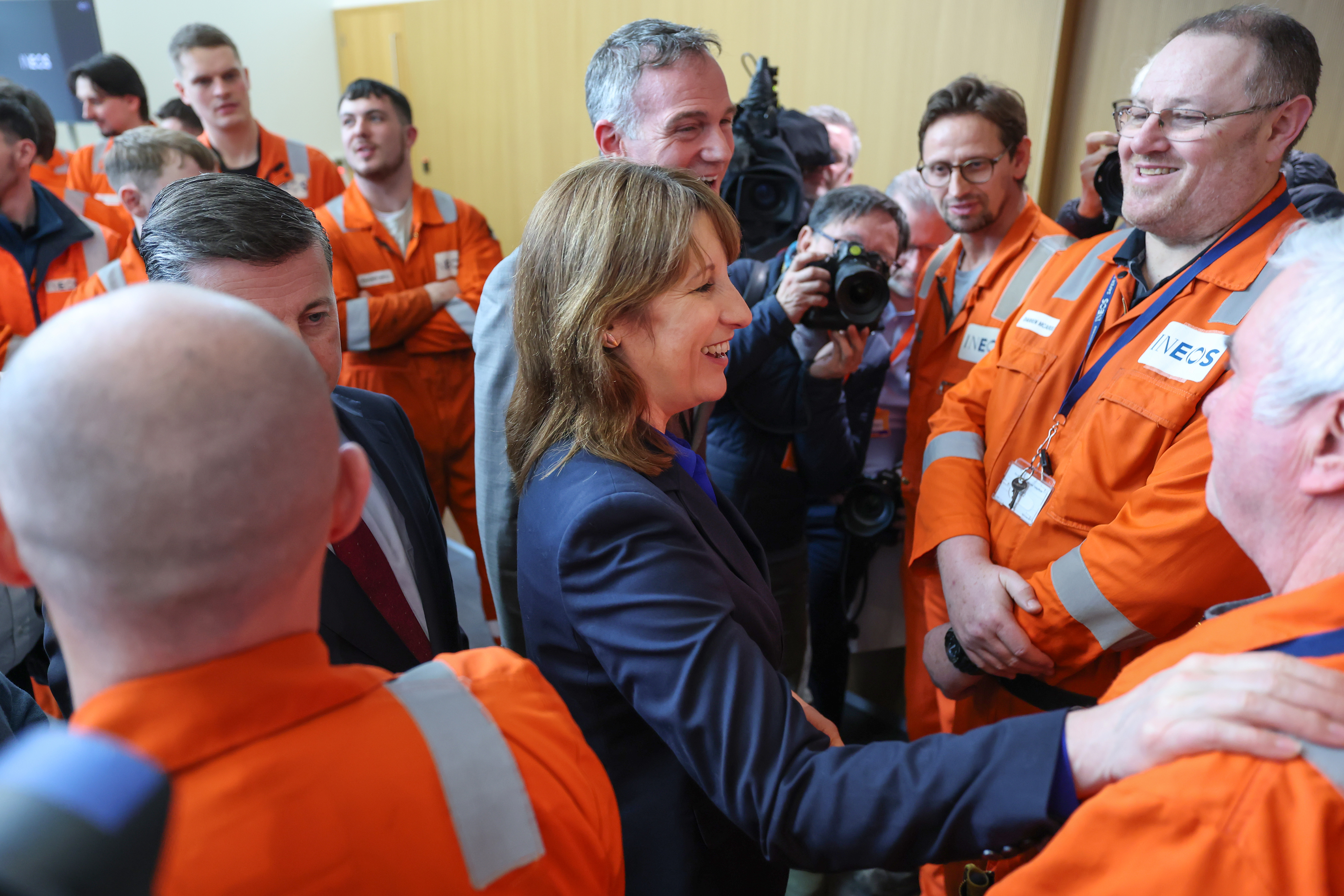 Rachel Reeves, Britain's Chancellor, speaking with INEOS employees in orange overalls at the Grangemouth ethylene plant.