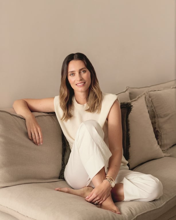 Ella Mills sitting on a couch