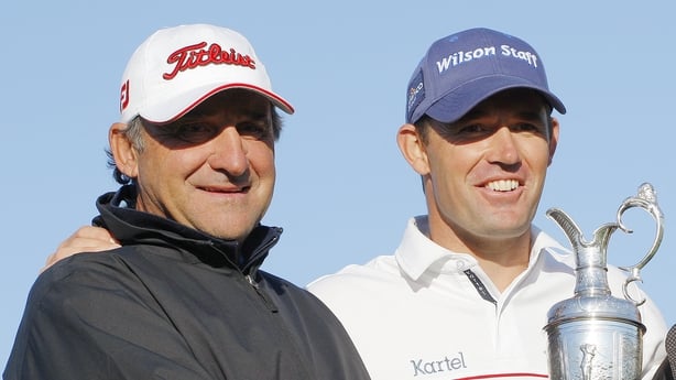 Padraig Harrington of the Republic of Ireland (R) poses with psychologist Bob Rotella and the Claret Jug after winning The Open golf tournament at Royal Birkdale in Southport in north-west England, on July 20, 2008.