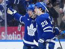 Toronto Maple Leafs forward Auston Matthews (34) celebrates a goal with teammate Matthew Knies (23) during a game against the Chicago Blackhawks.