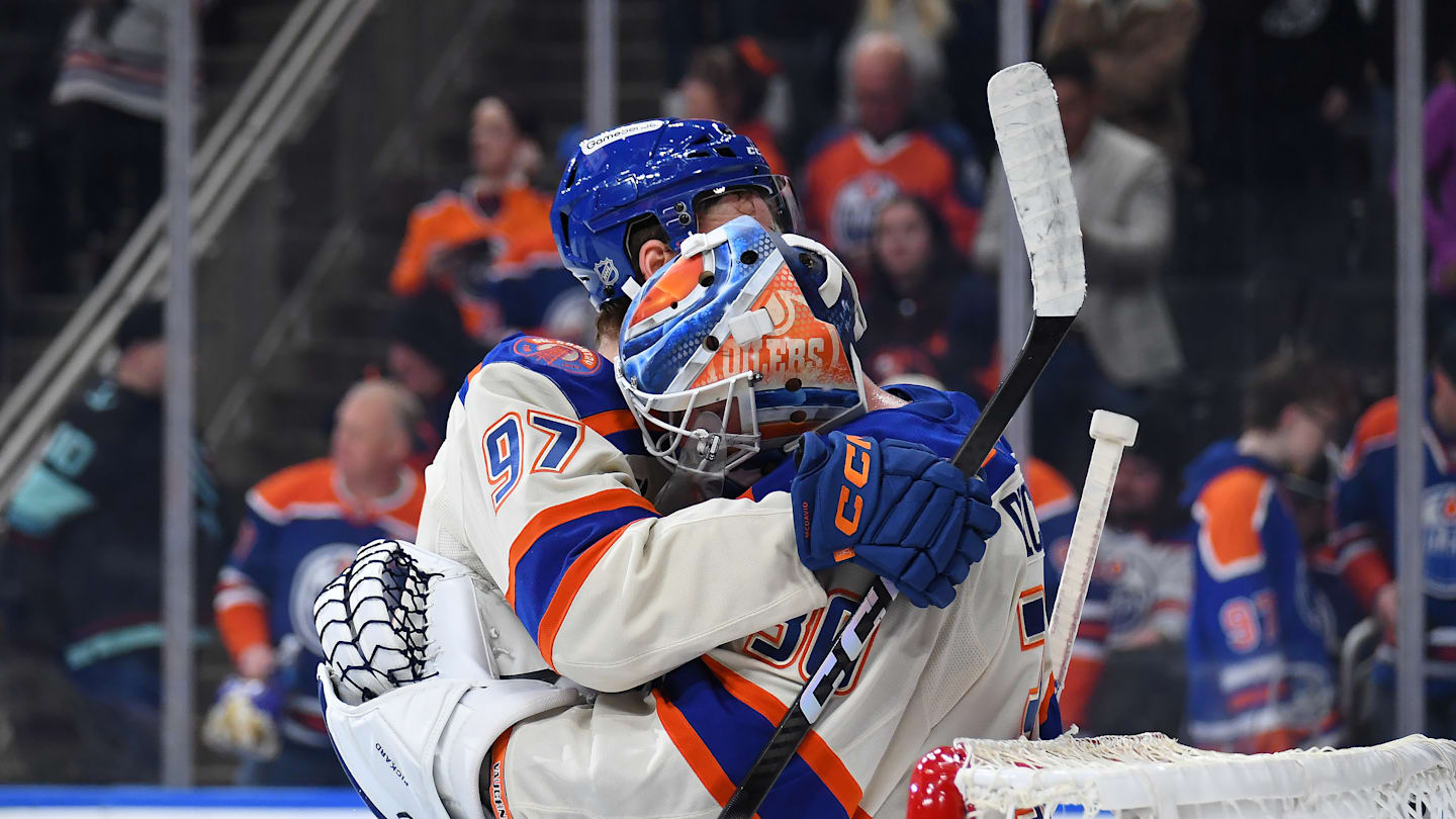 Connor McDavid shares a hug with Calvin Pickard