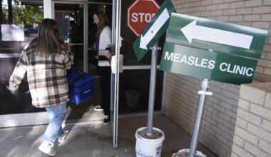 Health department staff members enter the Andrews County Health Department measles clinic carrying doses of the measles, mumps and rubella vaccine, April 8, 2025, in Andrews, Texas. (AP)